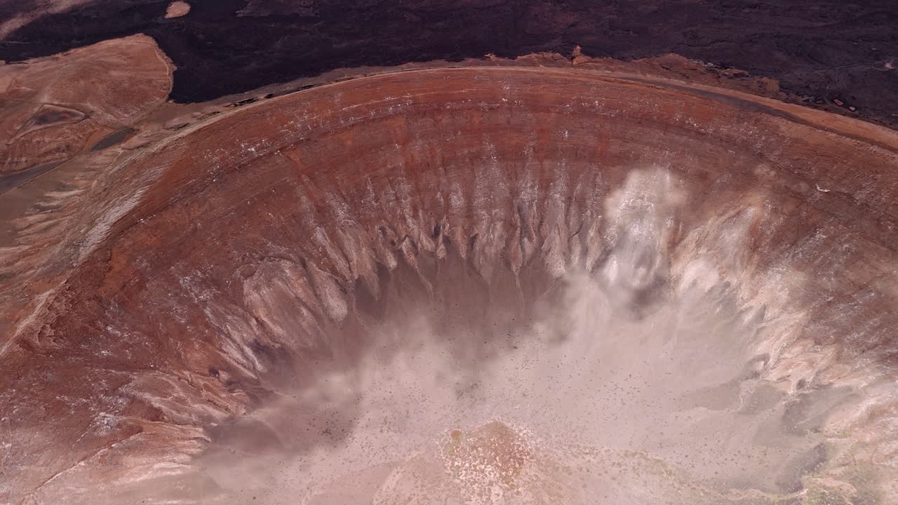Impressive aerial drone footage of Caldera Blanca, the largest volcanic crater with 1200 meters in Lanzarote, Canary Islands, Spain.