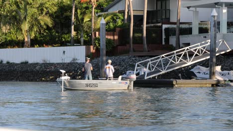 a small boat docks at a waterfront property