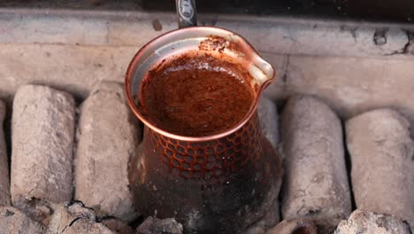 brewing turkish coffee in a traditional copper cezve