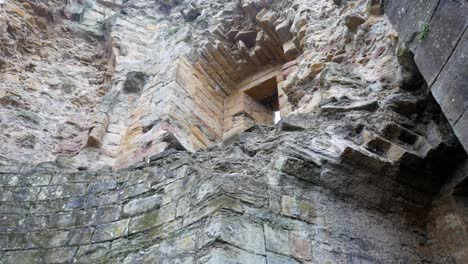 ancient basingwerk abbey abandoned historical landmark building stone walls right dolly upward looking