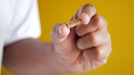 person holding a capsule