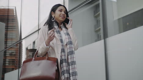 Businesswoman-talking-on-smartphone-on-street