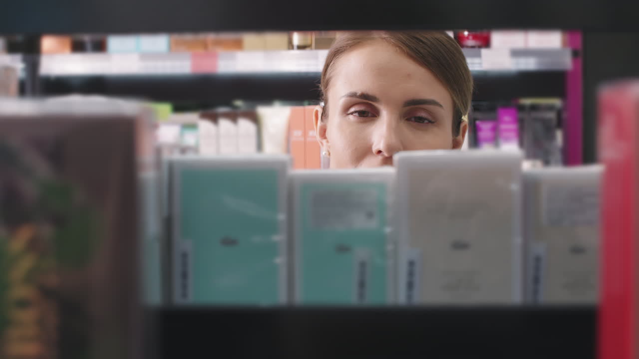 Woman Choosing New Perfume In Cosmetics Store