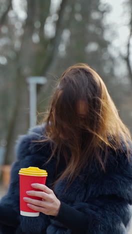 Woman with Coffee in a Park