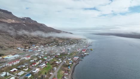 faskrudsfjordur town on a cloudy day in east iceland - aerial drone shot