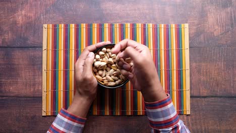Person eating pistachios