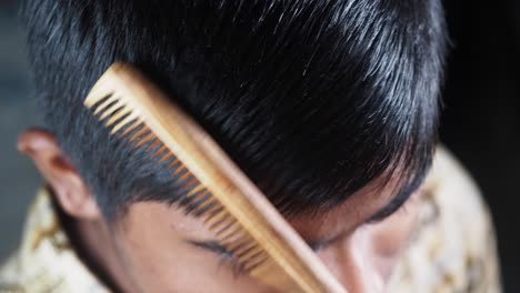 boy getting his hair combed