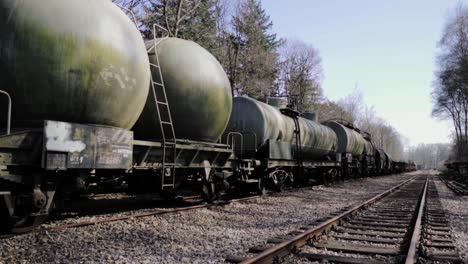 old military tank cars on train tracks