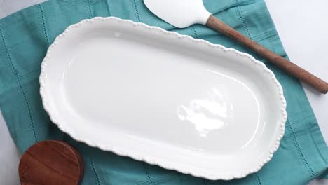 making a dessert called red raspberry tea cake made with fresh berries and vanilla buttercream frosting. great for tea parties. taking the vanilla cake out of the baking pan and placing on a plate