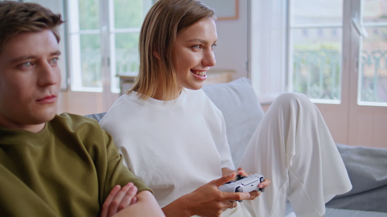 Teenagers playing video game woman winning online competition apartment closeup