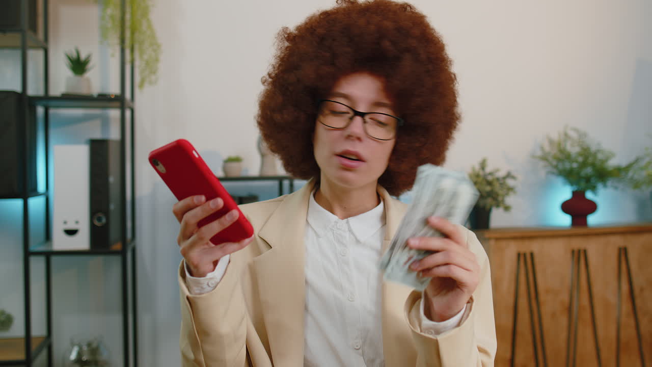 Rich businesswoman girl working on smartphone counting money cash, calculate earnings income profit