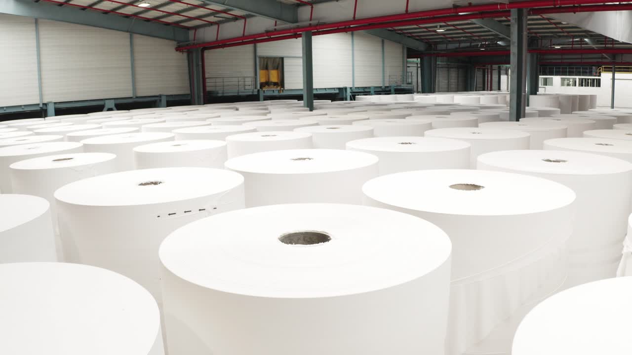 Shot of giant paper rolls kept at storage warehouse of paper towel factory in France.