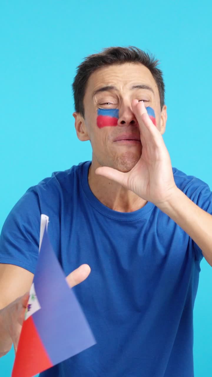 Man cheering for Haiti during a match that is lost