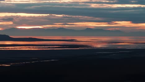 Static-drone-shot-of-cars-driving-on-a-highway-next-to-Great-Salt-Lake