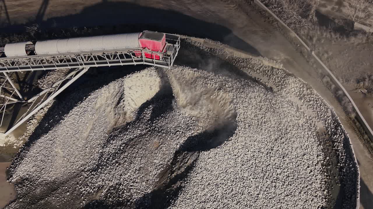 Quarry operation showing stone processing and transport through machinery