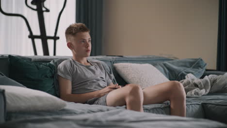 teenager playing video games at home
