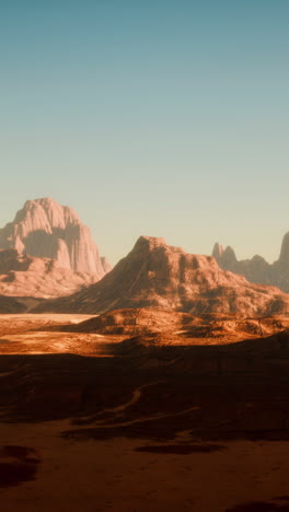 a desolate and rocky desert landscape with a mountain range in the background