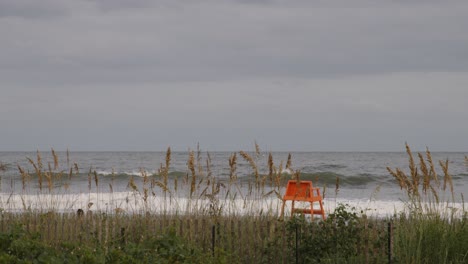 dunes and lifeguard chair along ocean in myrtle beach, south carolina
