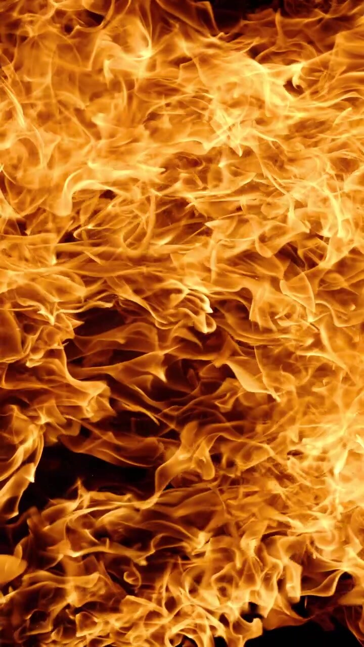 Vertical video Abstract orange fire flames background texture.