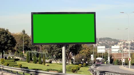 advertising billboard green screen on sidelines of expressway with traffic