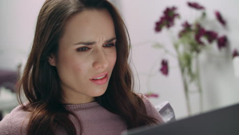 Unhappy-business-woman-face-reading-online-news-at-laptop-screen