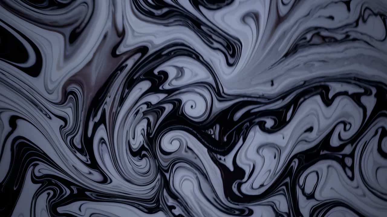 Abstract black and white swirling patterns create a mesmerizing effect