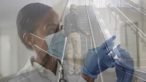 animation of female doctor with vaccine over senior man wearing face mask