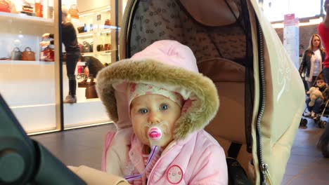 baby in stroller at a shopping mall
