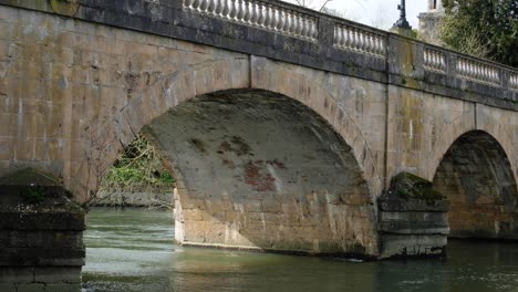 historical stone bridge over the river thames flowing through arches in the historic market town and civil parish of wallingford, south oxfordshire, england