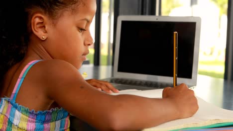 Schoolgirl-doing-homework-in-library-4k
