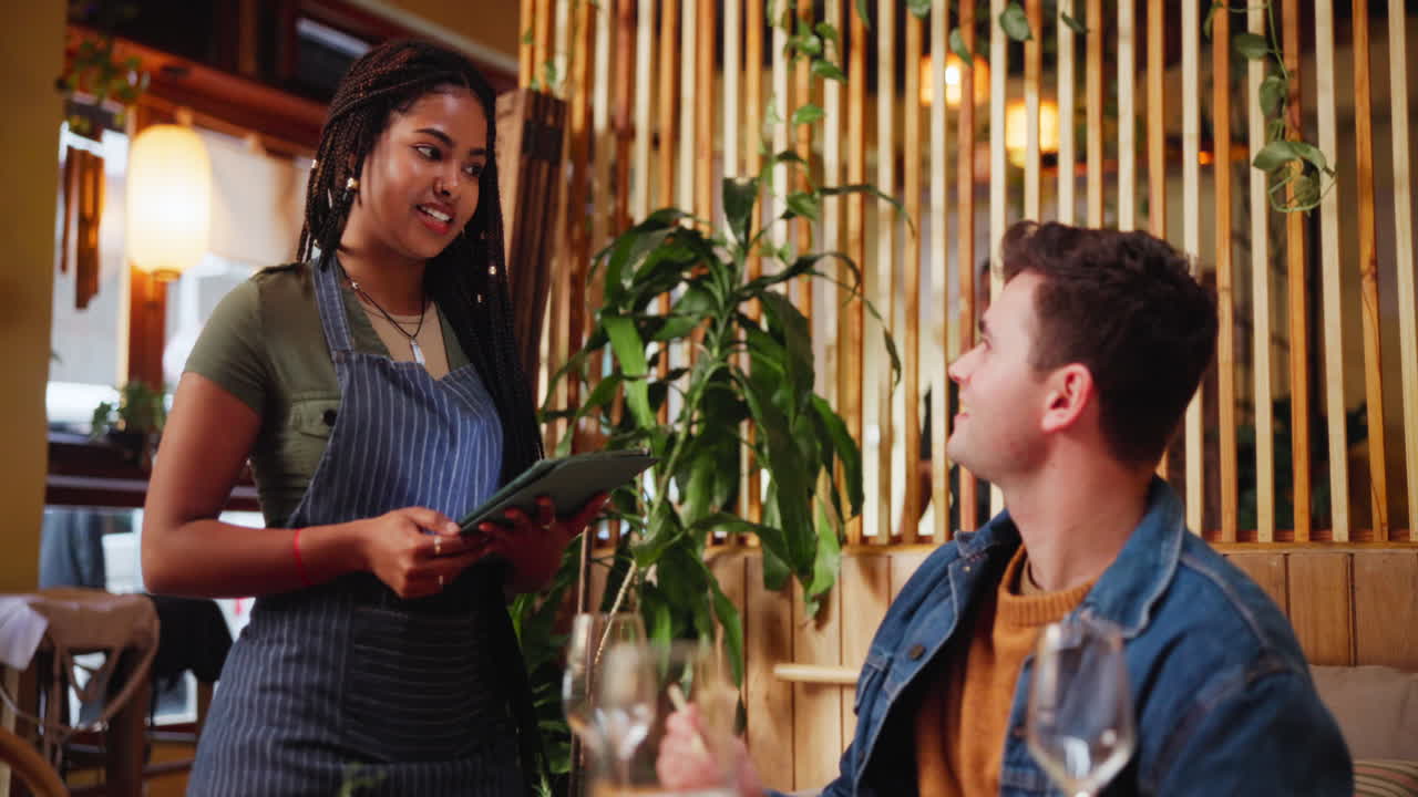 Waitress taking order from customer at restaurant