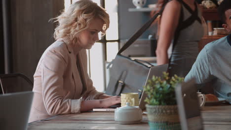 female customer in coffee shop using laptop shot on r3d