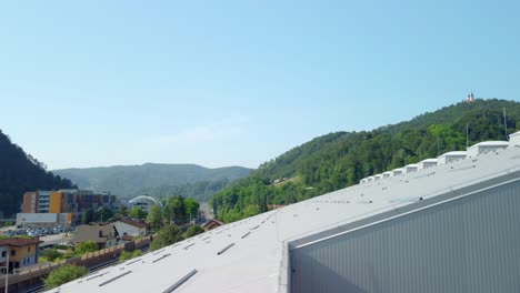 Big-sports-hall-covered-with-white-insulation-panels-and-light-plastic-domes-on-top-of-it