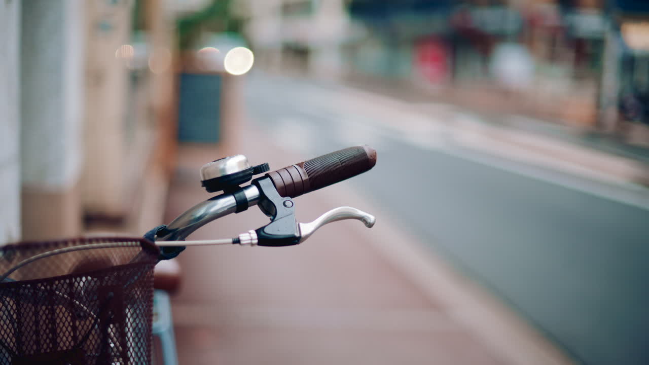Close up of a bicycle handle and bell in an empty street