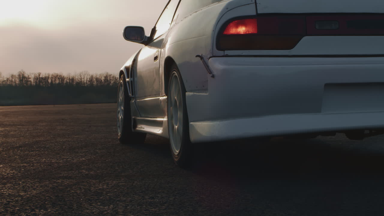 White Drift Car on a Track at Sunset