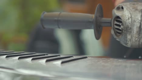 polishing the aluminum bonnet of a vintage car