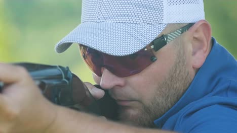 sportsman shoots from a double-barreled shotgun, a sports field for a shooting test is shooting at flying skeet