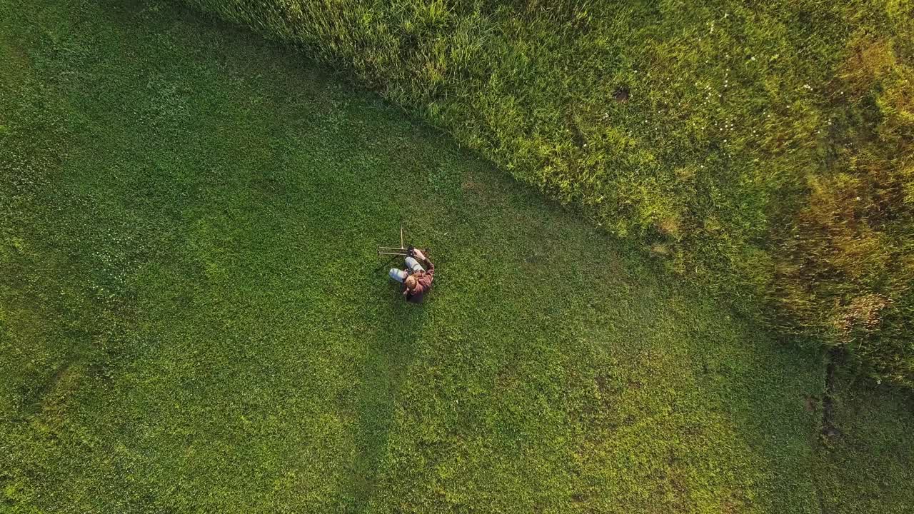 Aerial Of Young Male Filmmaker - Photographer Setting Up Timelapse Slider For Sunrise Timelapse Golden Hour Cinematic 4K