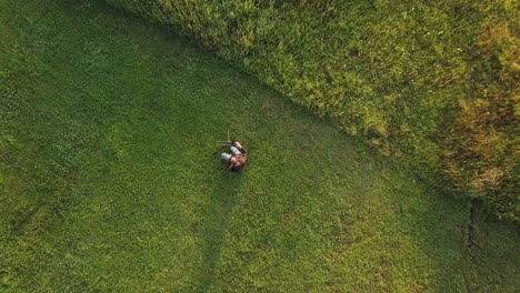 aerial of young male filmmaker - photographer setting up timelapse slider for sunrise timelapse golden hour cinematic 4k