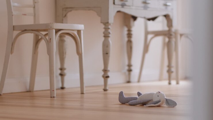 toy bunny rabbit teddy bear lying on wooden floor at home childhood concept