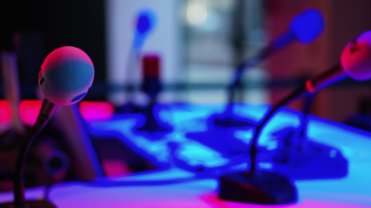 Cannes, France - March 2, 2025: Close up of a microphone on a blurred background with blue and red lights at the International Games Festival