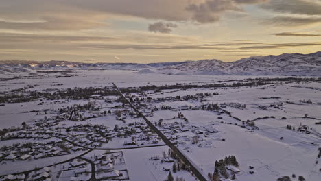 Oakley-Utah-Aerial-v3-panoramic-panning-view-drone-flyover-town-area-blanketed-in-a-vast-expanse-of-glistening-snowfields-and-pristine-mountainscape-at-sunset---Shot-with-Mavic-3-Cine---February-2023