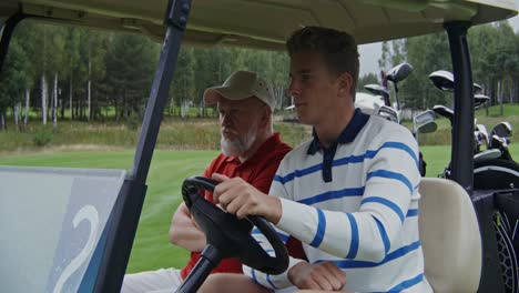 two men in a golf cart