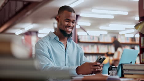 man using a phone in the library