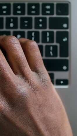 hand typing on a laptop keyboard with a ring