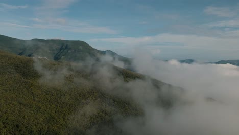 aerial view of majestic mountain peaks above fluffy clouds, perfect for nature and travel projects