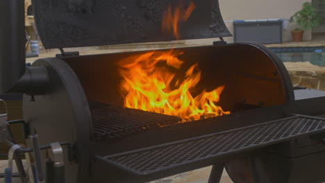 large fire in backyard poolside bbq pit cleaning smoker