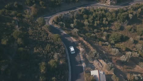 White-car-driving-through-greek-mountains