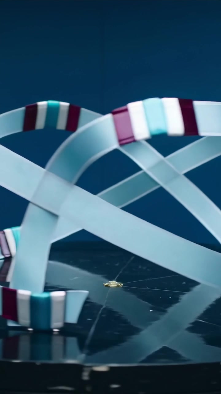 Vertical video: Loops starting ribbons shifting over studio set, moving segments and gold disc