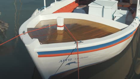 carvel-built traditional greek fishing boat with beautiful varnished bow planking